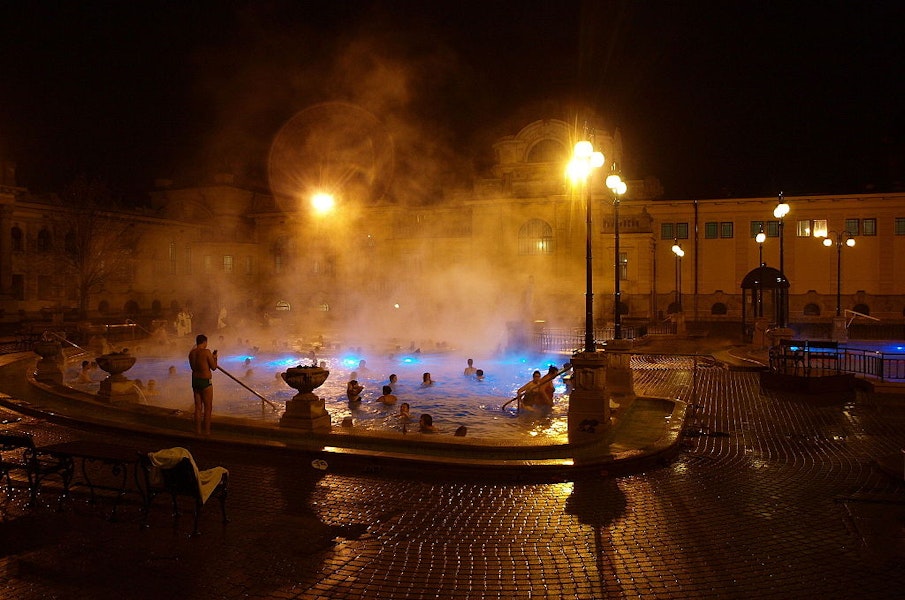 people bathing in a thermal pool at szechenyi baths