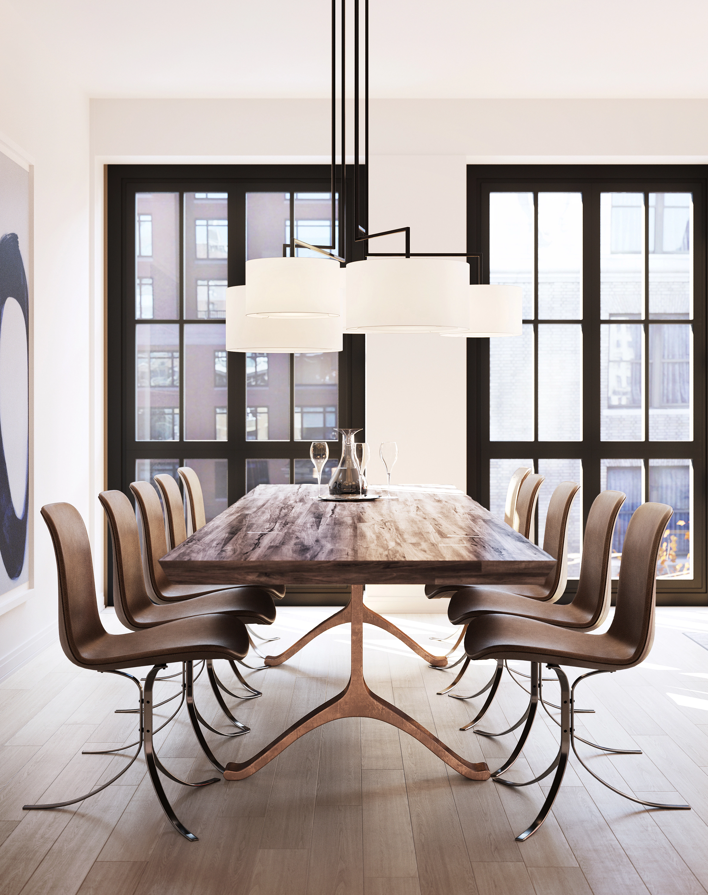 Dining room at 915 West End Avenue in NYC, featuring a rustic wooden dining table with sculptural legs, surrounded by modern leather chairs with curved metal bases. Large black-framed windows provide ample natural light, while a contemporary multi-shade chandelier adds a sophisticated touch to the space.