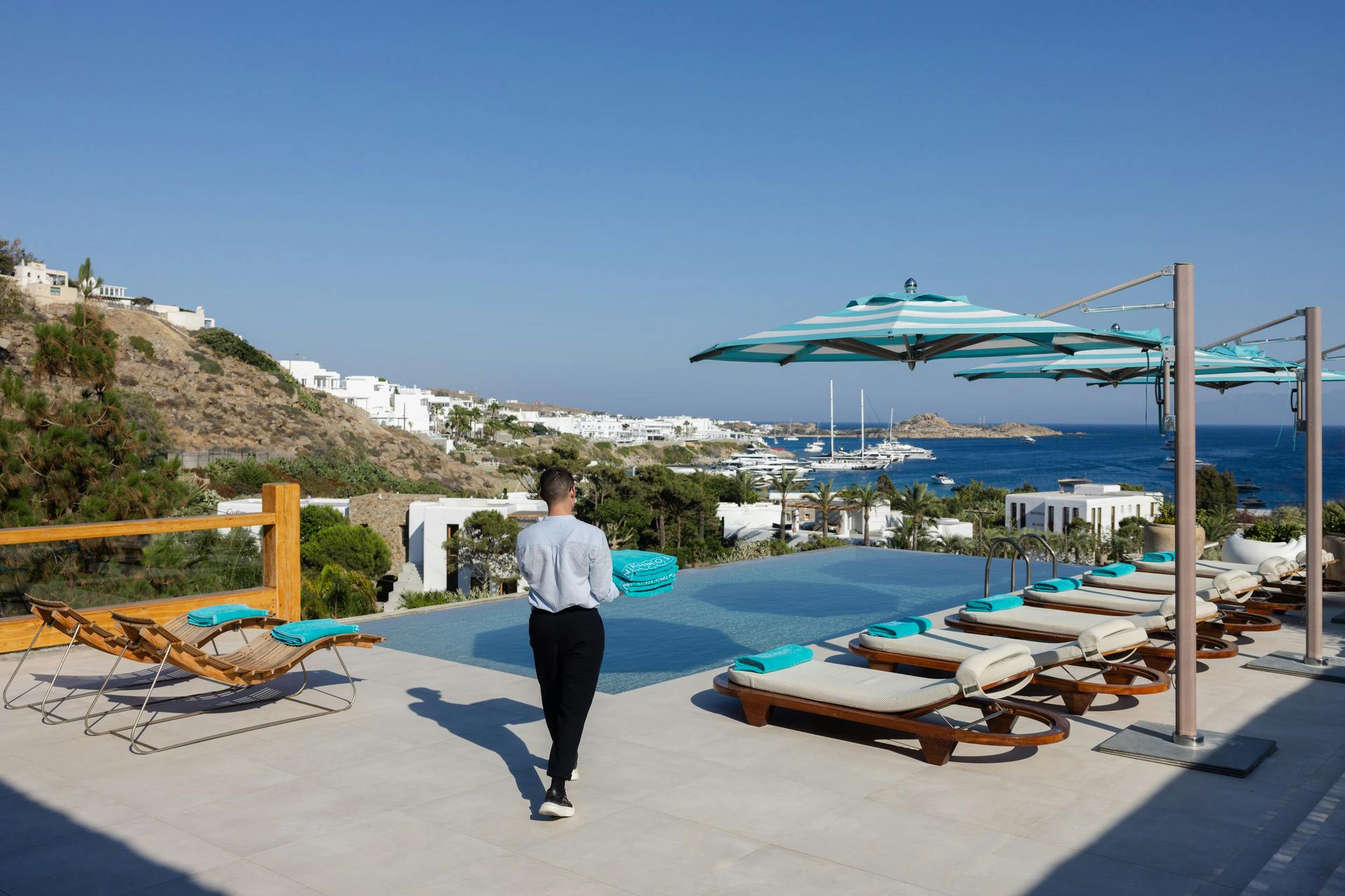 Butler walking toward private pool at Nammos Villas Mykonos