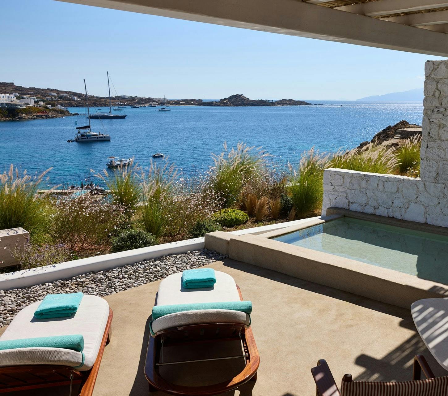 Two sunbeds on suite terrace with panoramic view of Mykonos