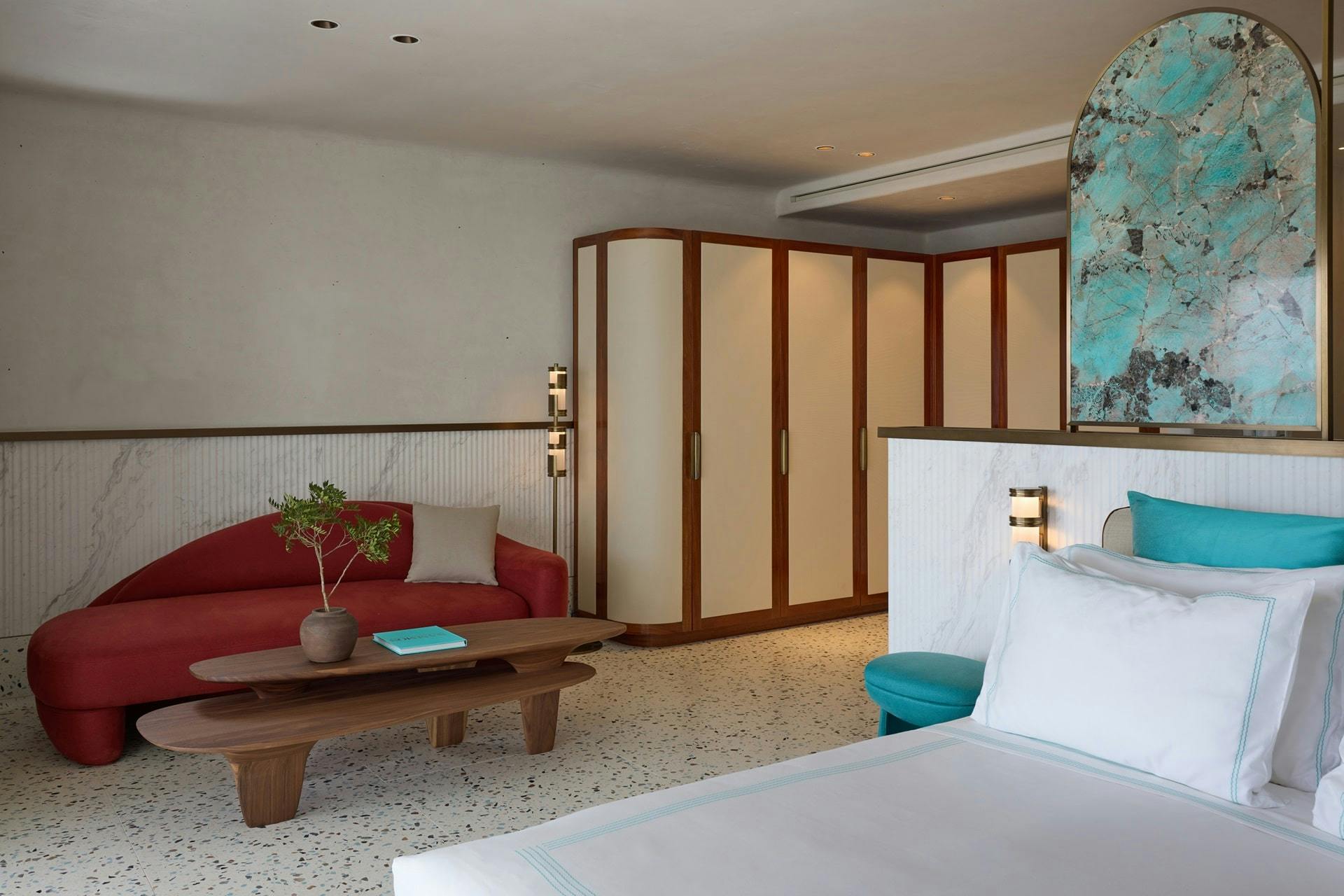 Bed, sofa and interior design features of a suite at Nammos Hotel & Villas Mykonos