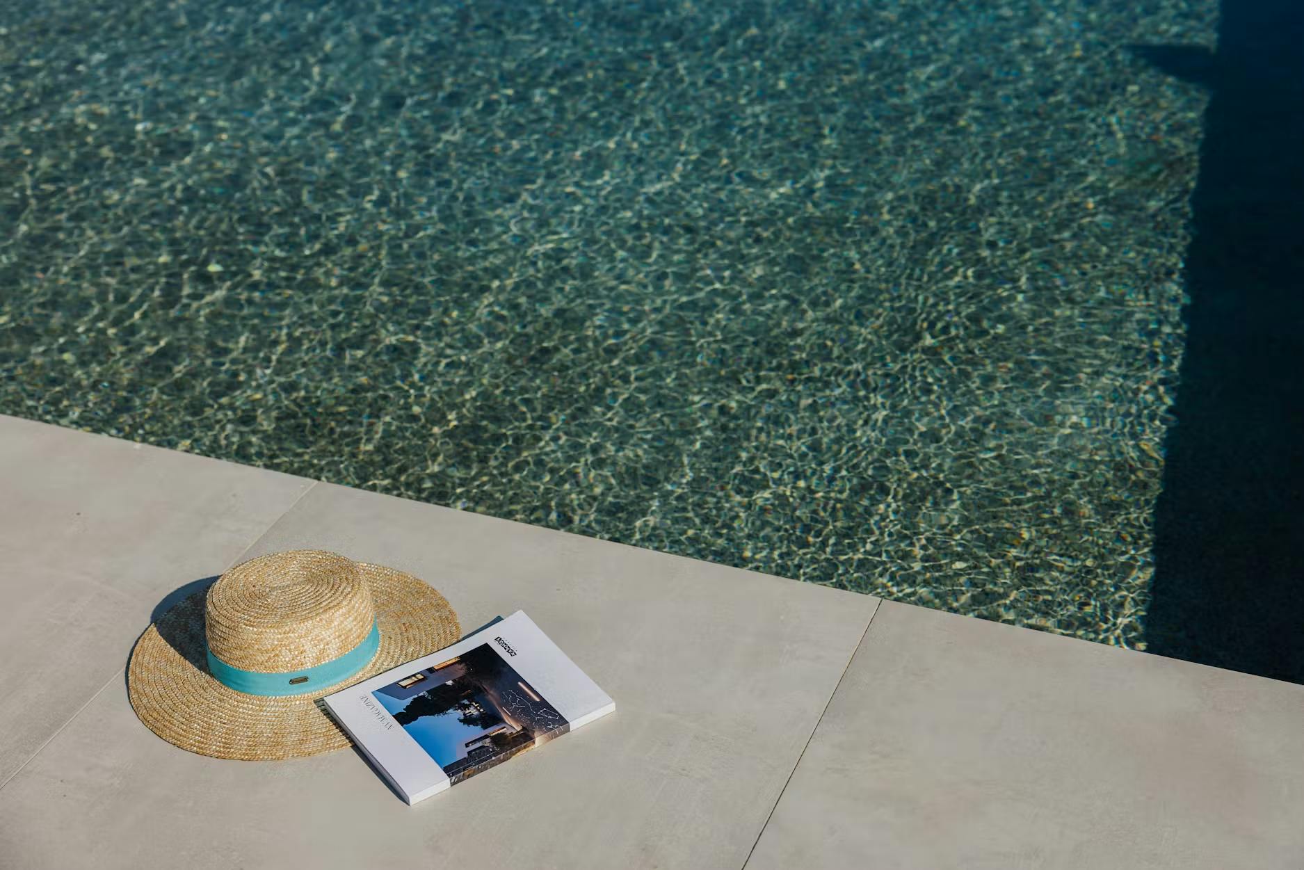 Hat and magazine next to water