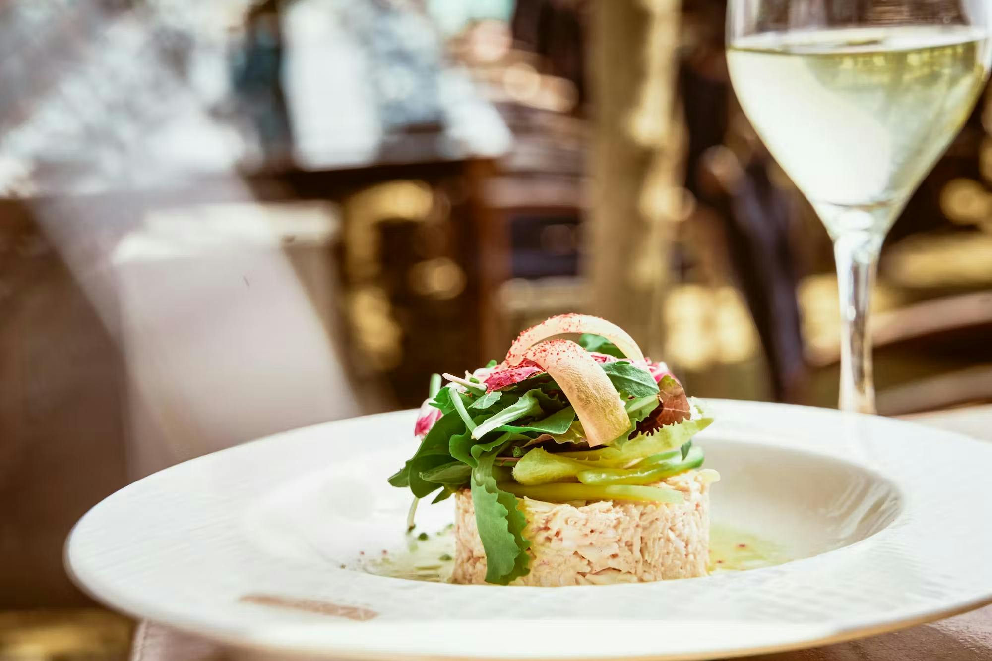 Minced crab with vegetables on a plate on the table