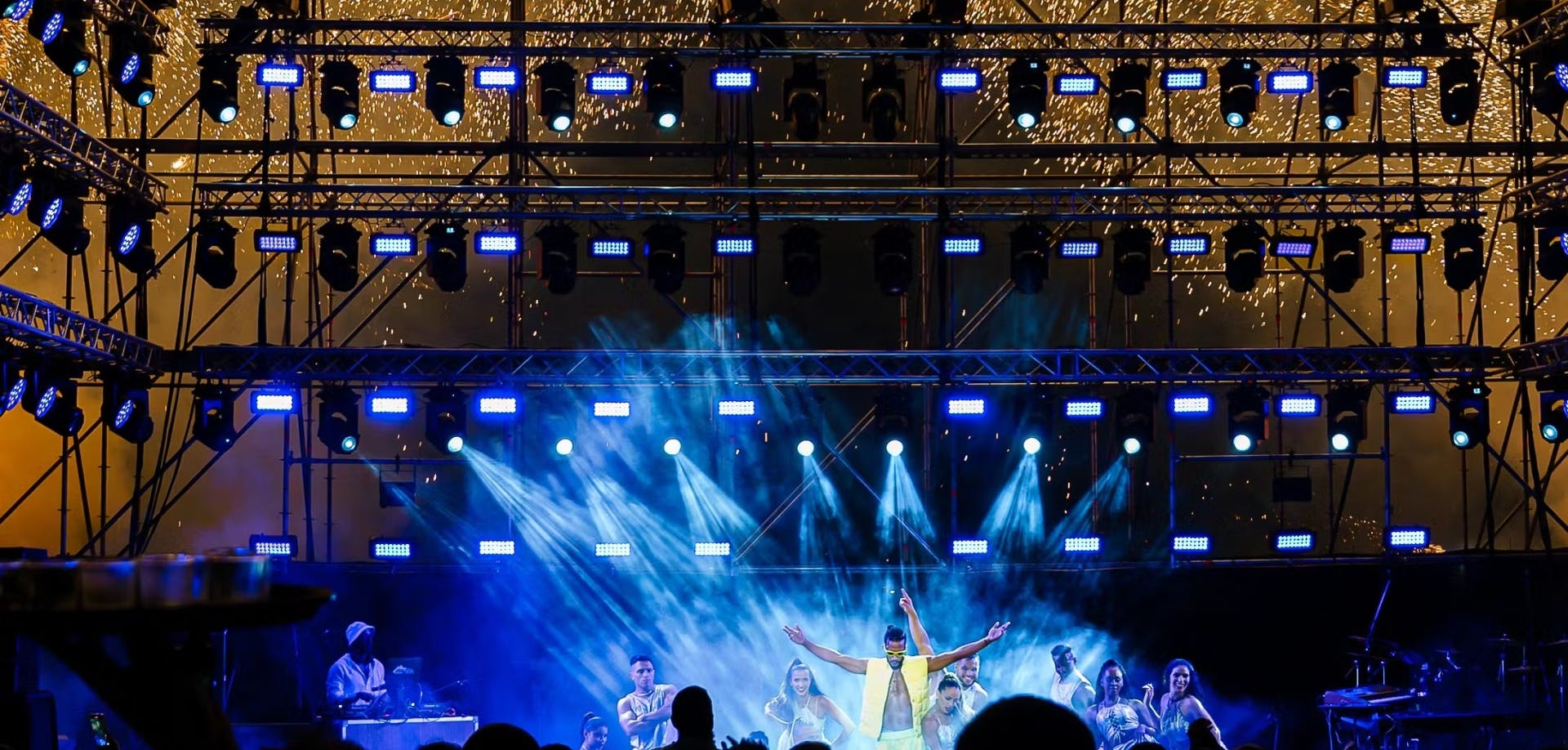 Performer on stage with blue light effects and fixtures