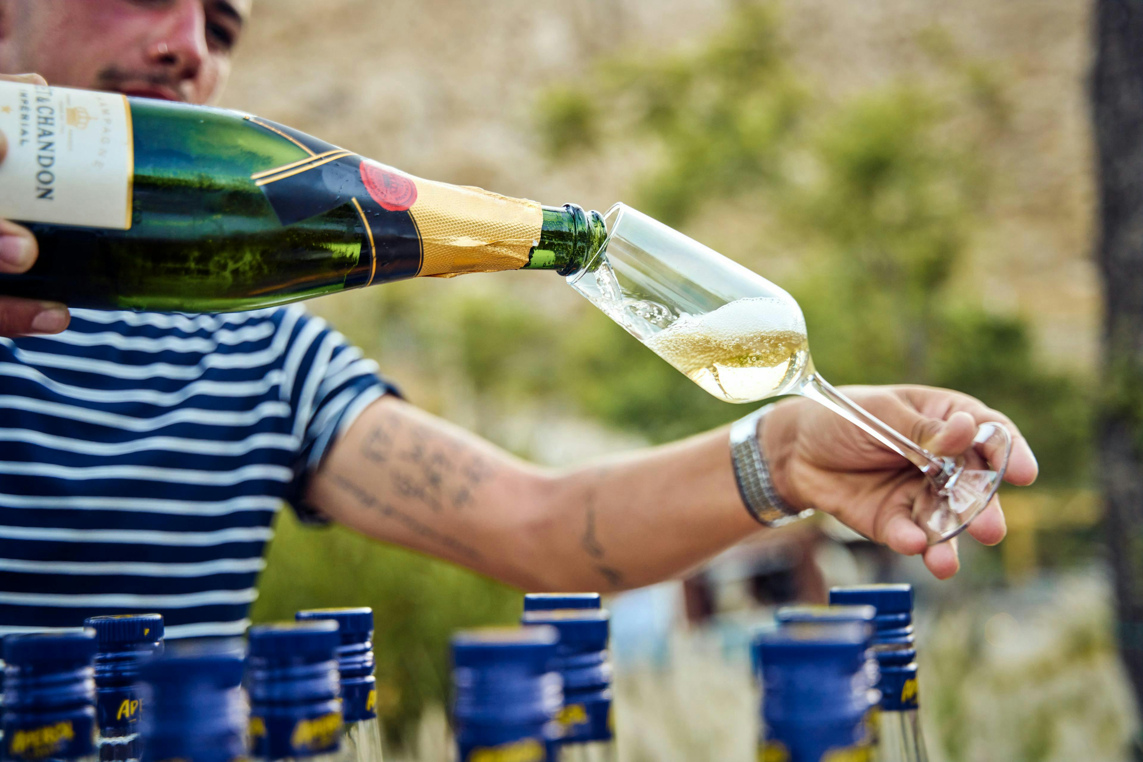 Close up of hand pouring champagne into a glass