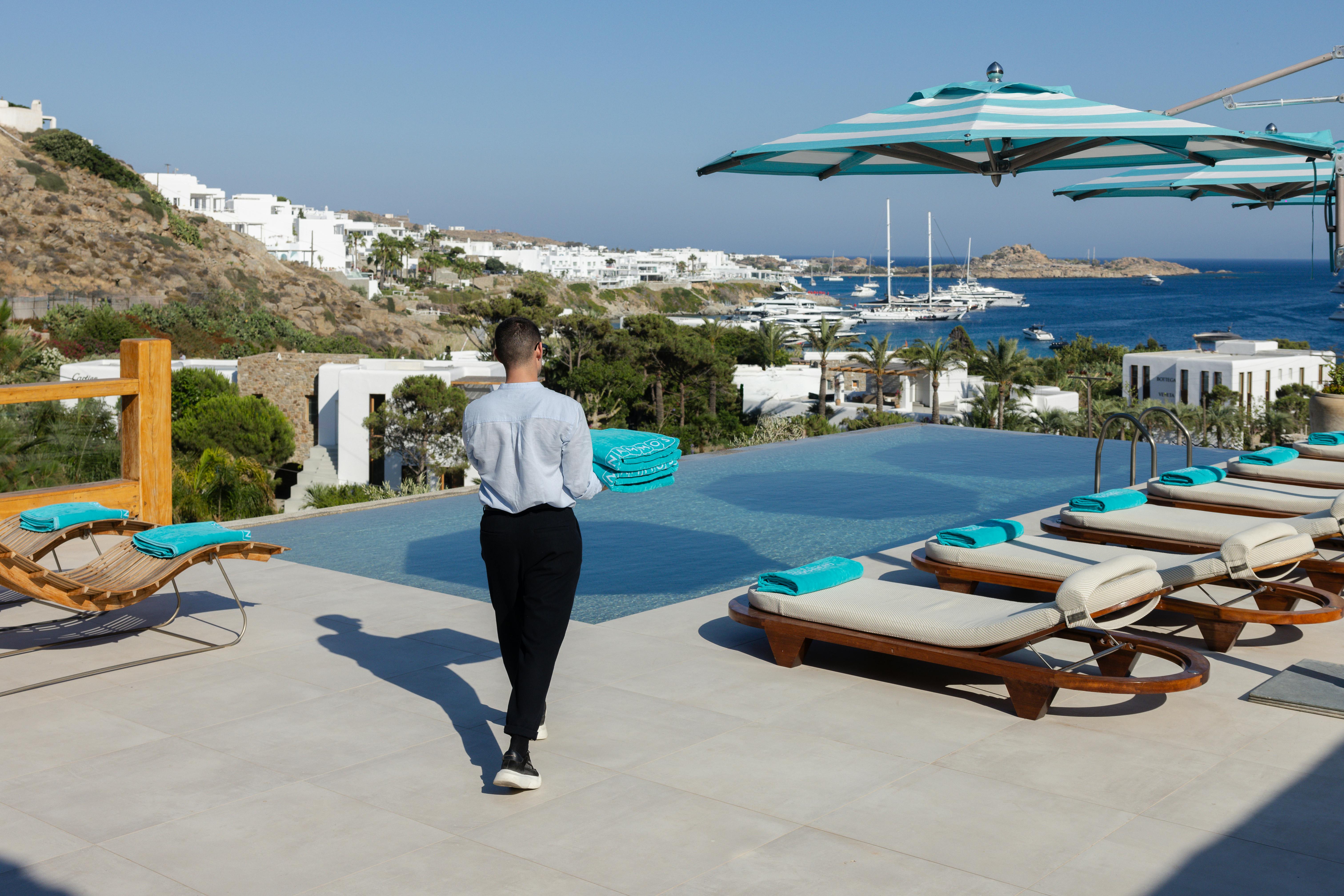 Butler walking towards private pool at Nammos Hotels & Villas Mykonos