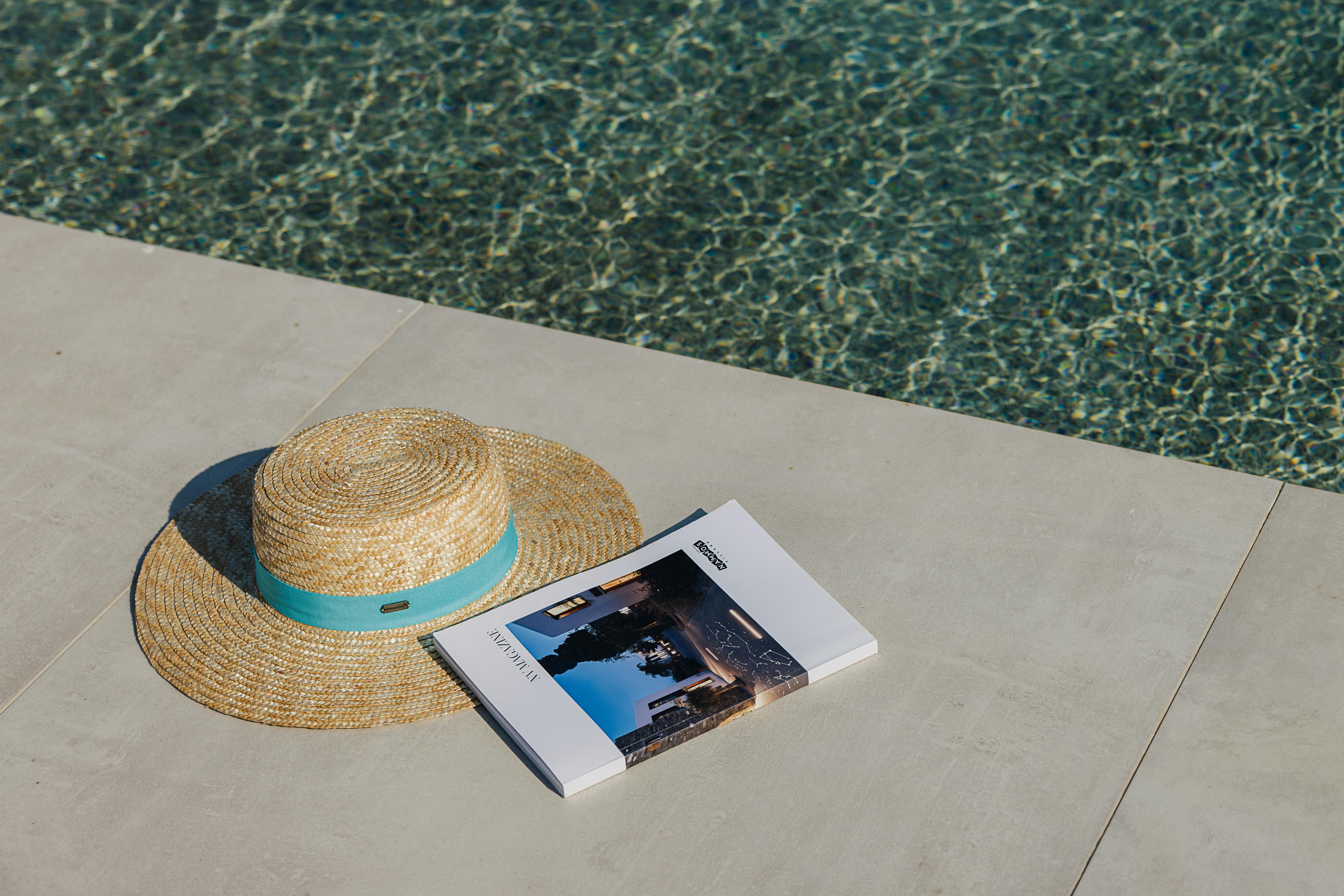 Hat and magazine next to water