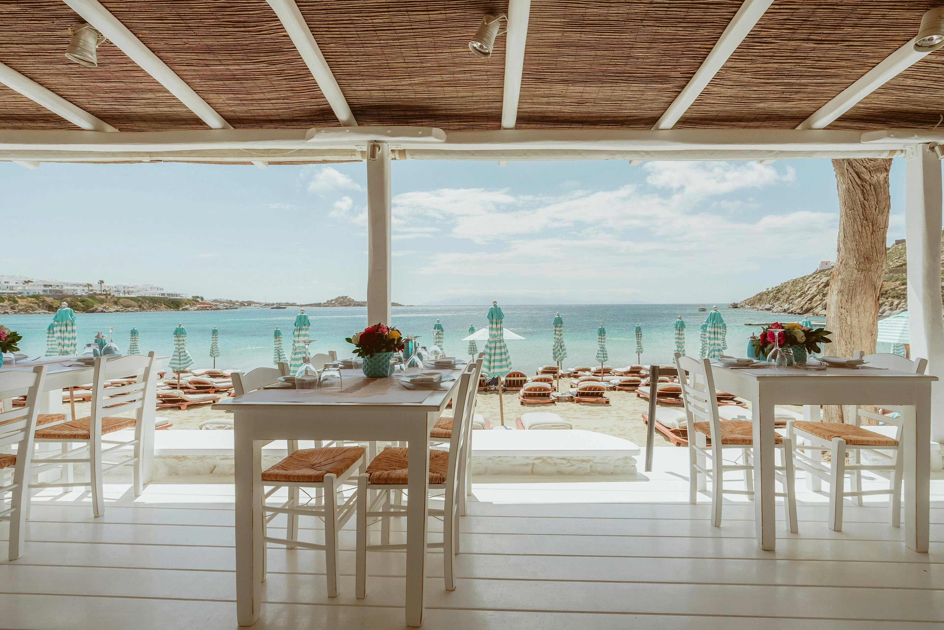 Mykonos restaurant overlooking parasols and Psarou Beach