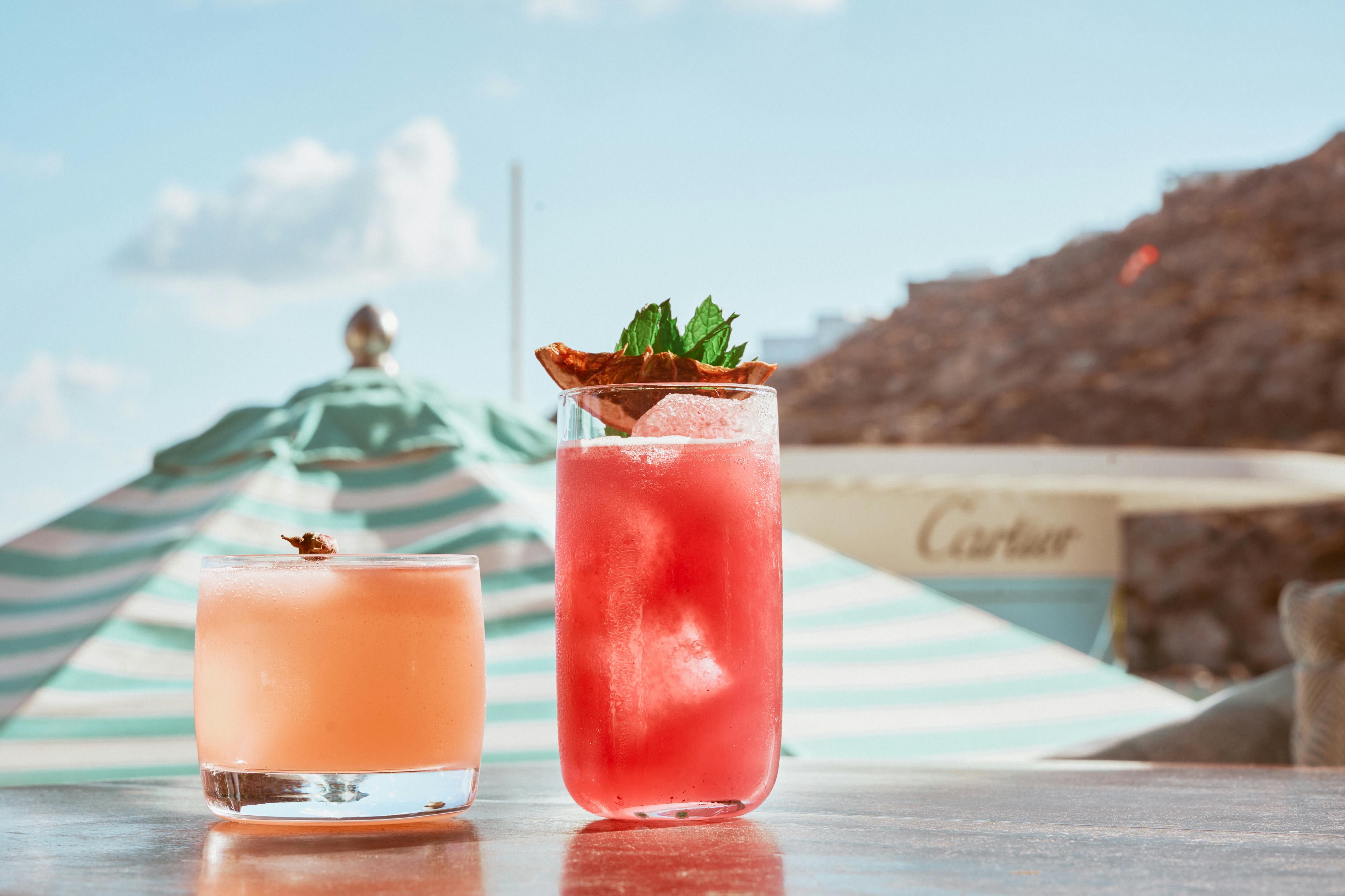 Cocktails against parasol and mountains in Mykonos