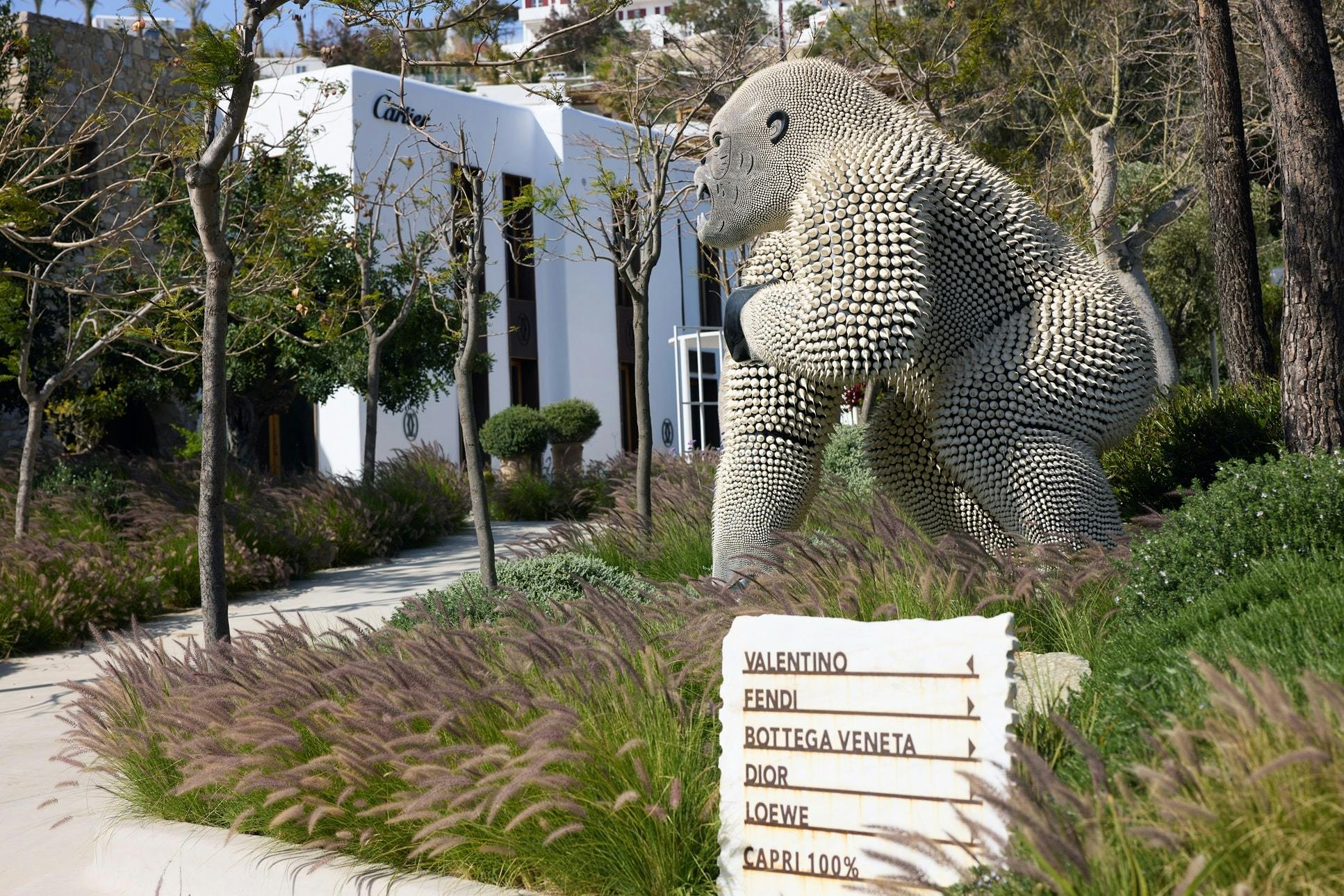 Monkey sculpture and entrance signage to Nammos Village