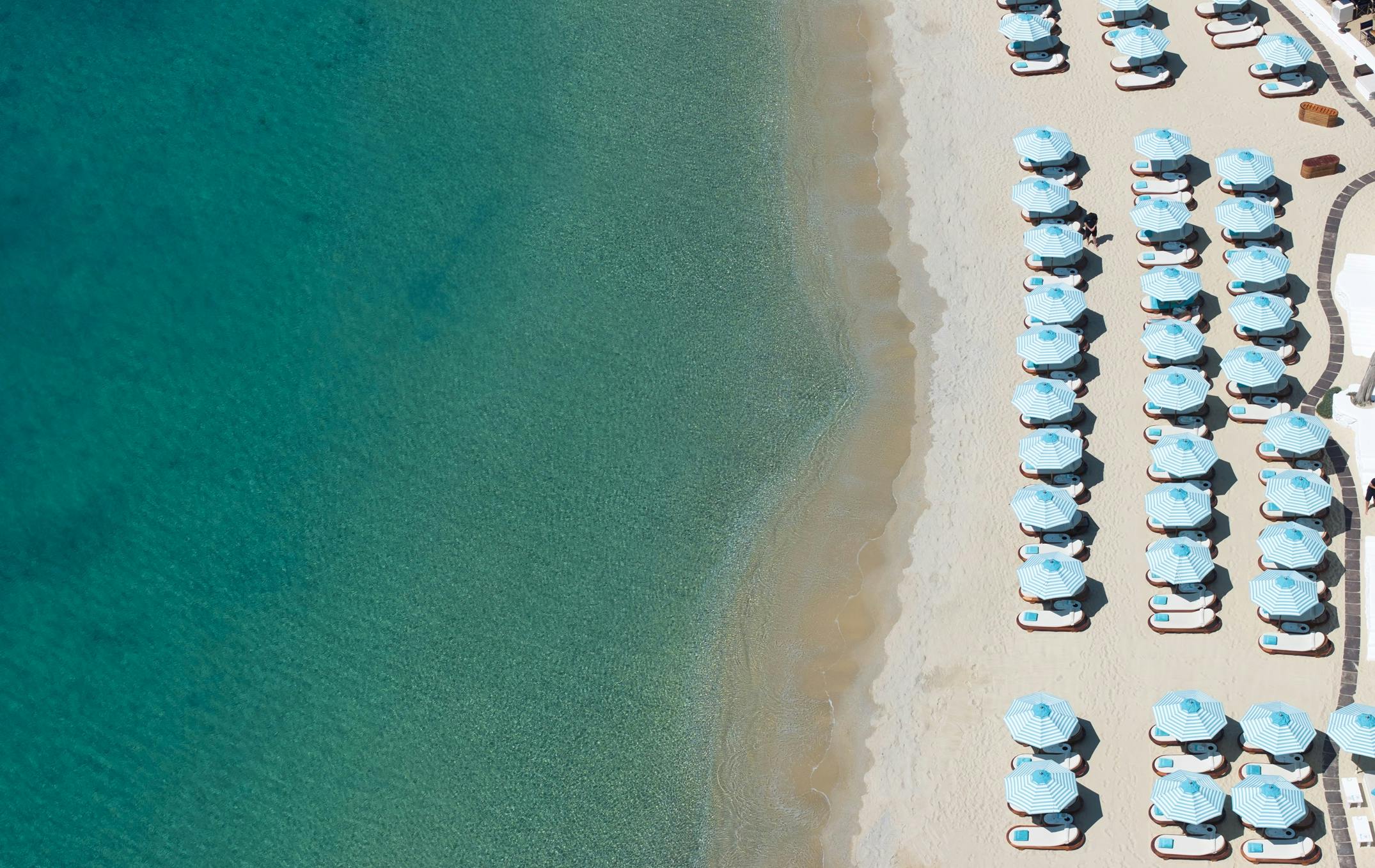 Birds eye view of parasols, beach and sea at Nammos Beach