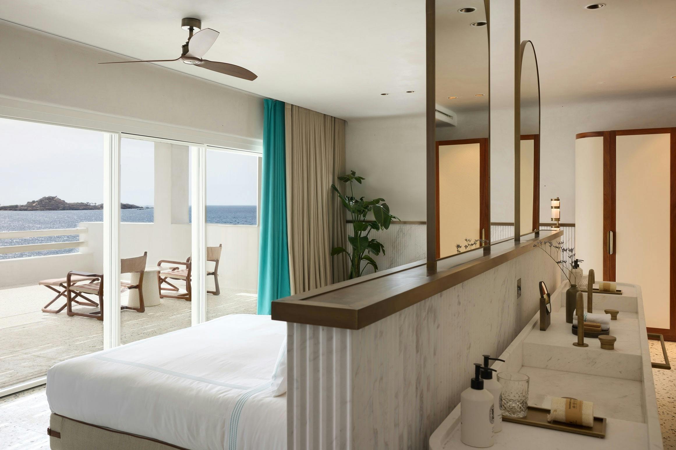 Bed, bathroom and terrace showcasing the luxury interior of suites at Nammos Hotel Mykonos