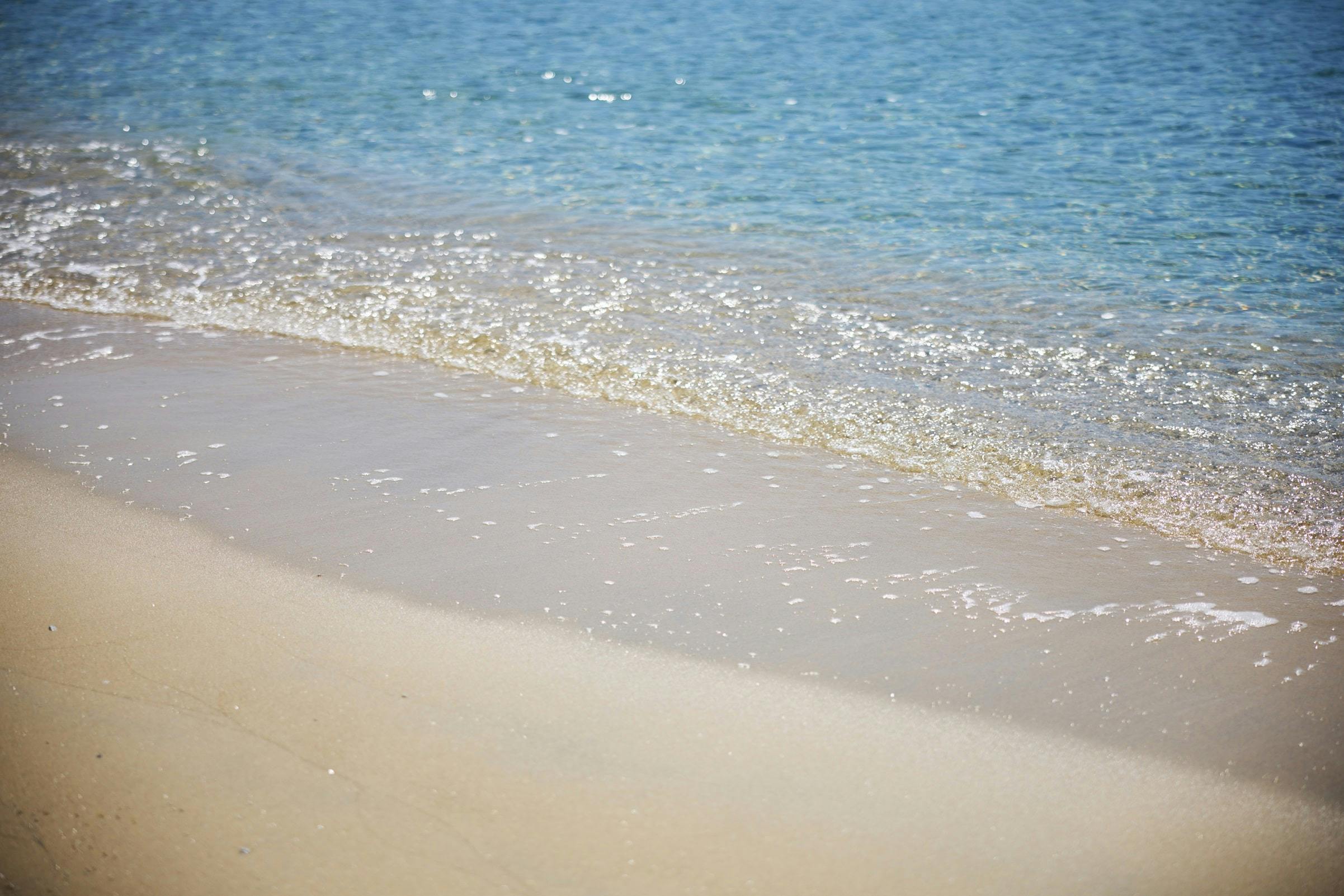 Sand and sea water at Psarou Beach