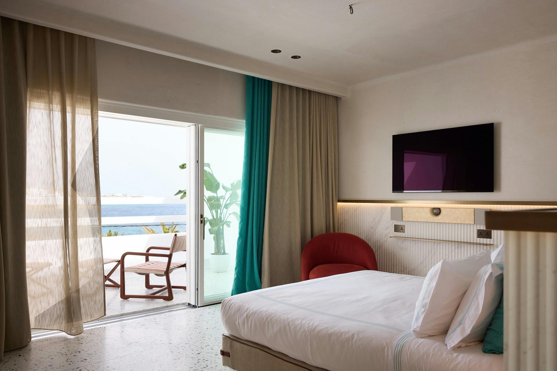 Bed and terrace showcasing the luxury interior of rooms at Nammos Hotel Mykonos