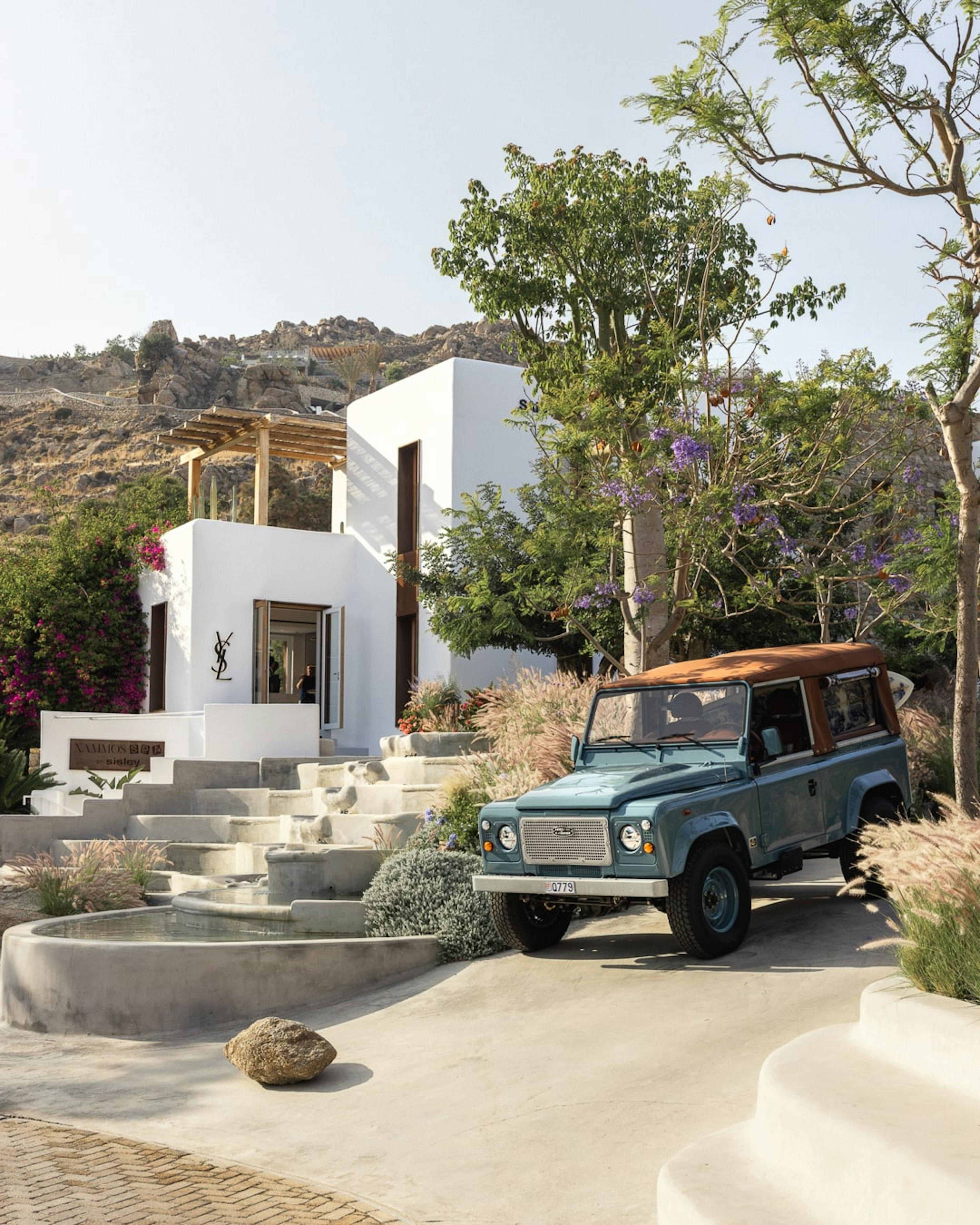 4x4 car outside a white stone washed house in Nammos