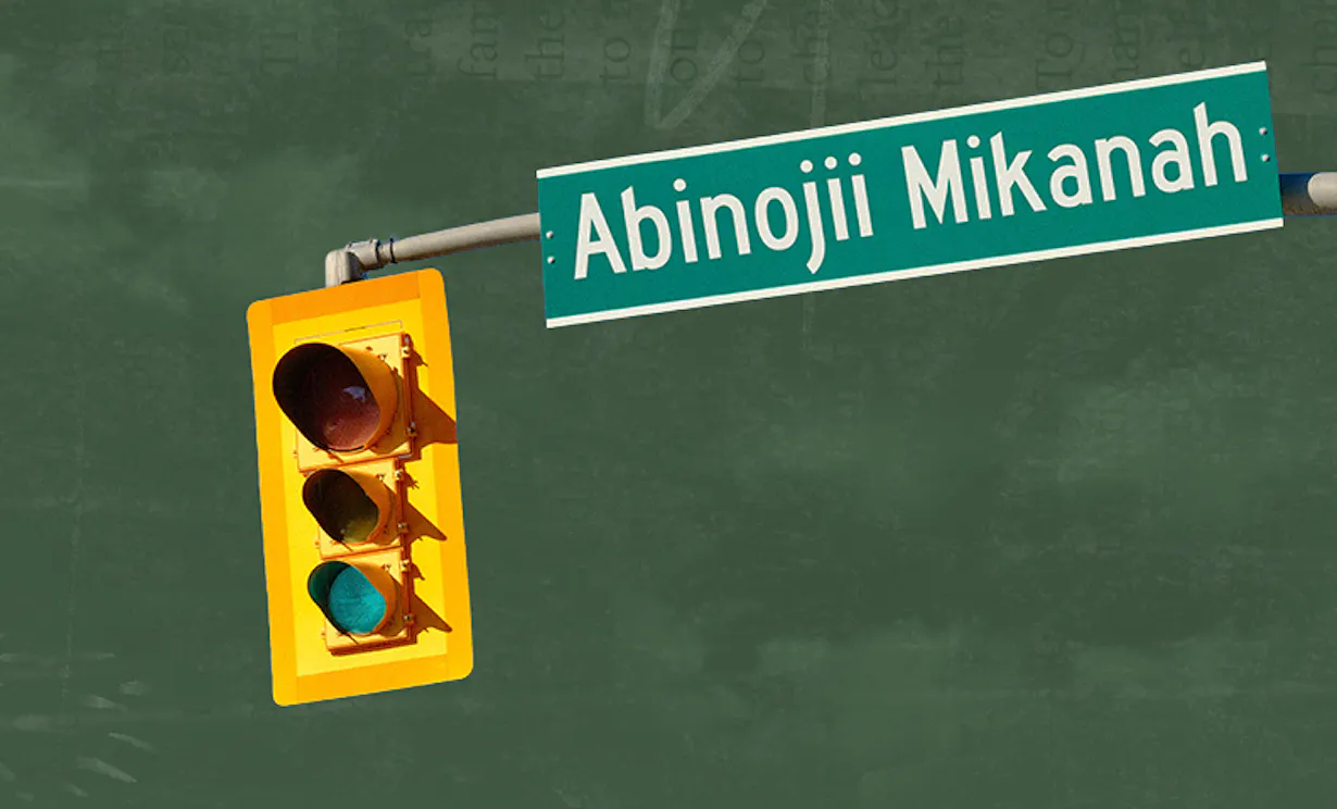 Abinojii Mikanah street signage with a traffic light.