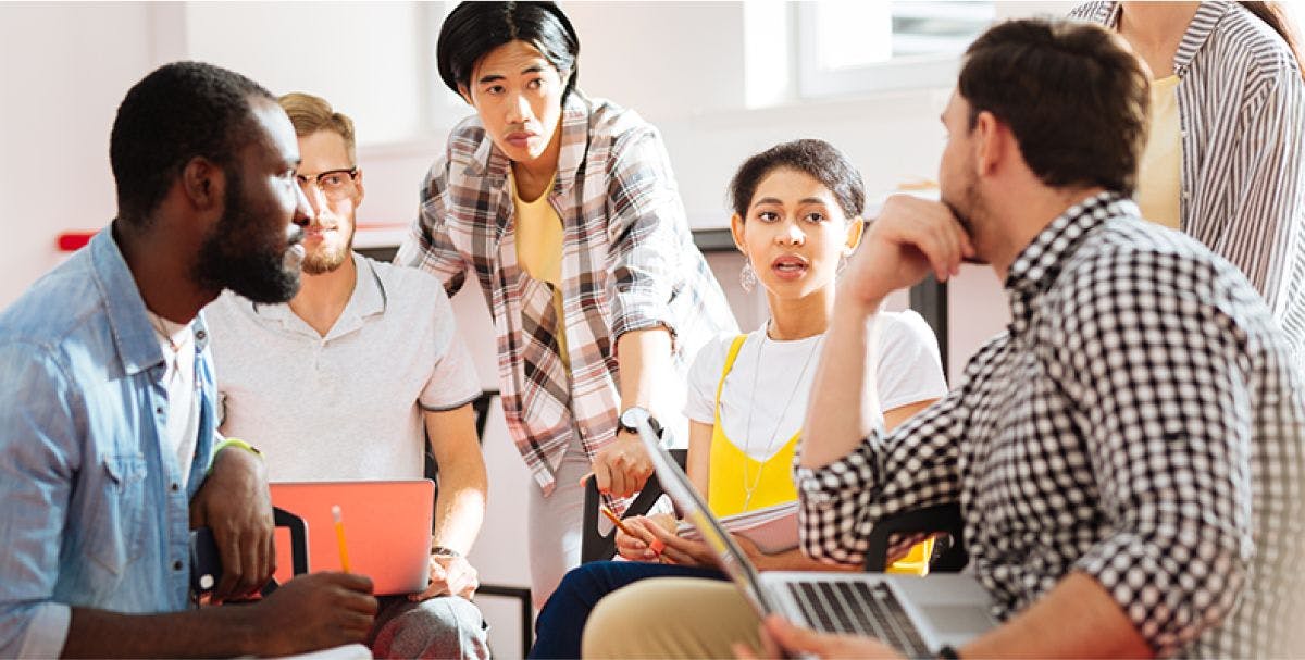 Group of diverse colleagues brainstorming together in a meeting