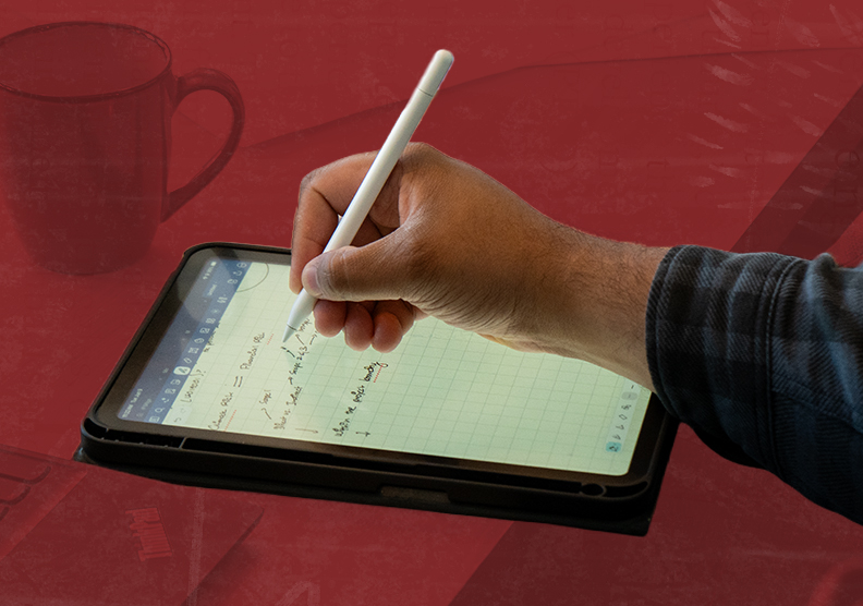 Hand writing notes on a tablet
