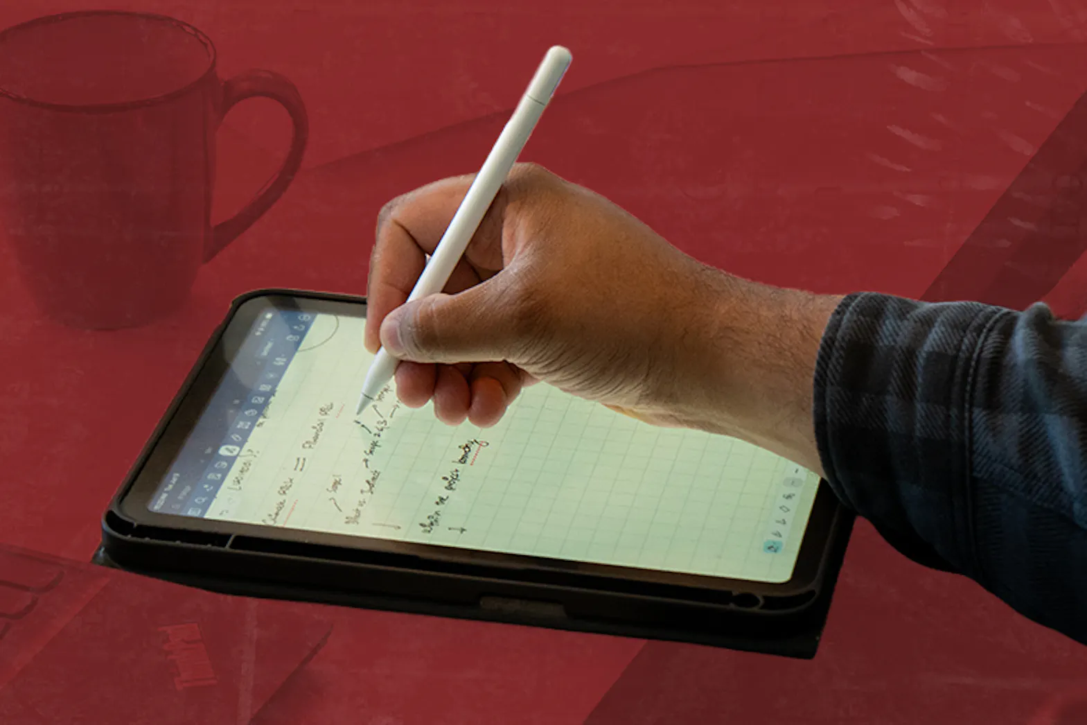 Hand writing notes on a tablet