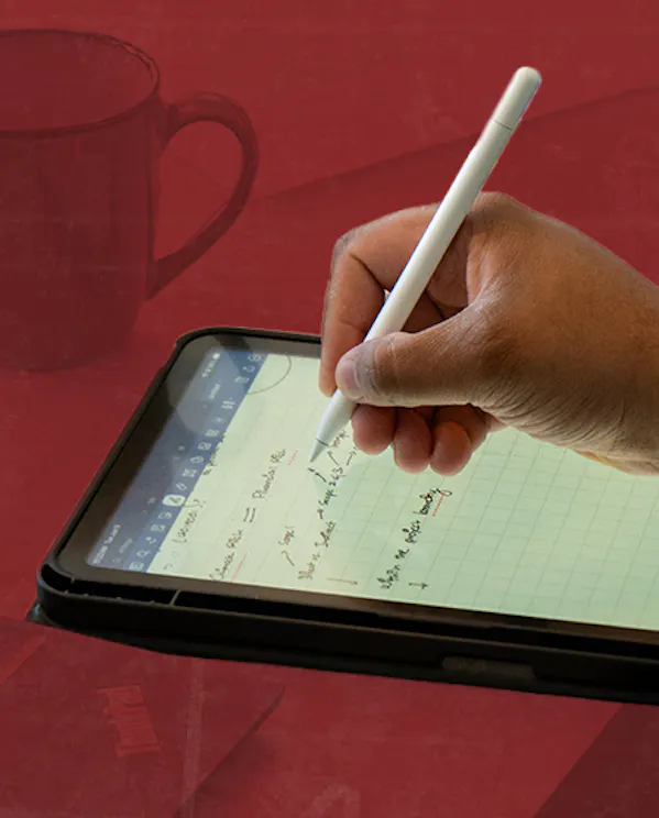 Hand writing notes on a tablet