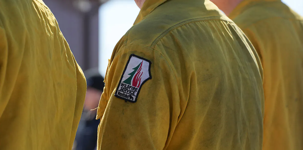 A close up view of a yellow jacket with a fire safety patch on the sleeve.