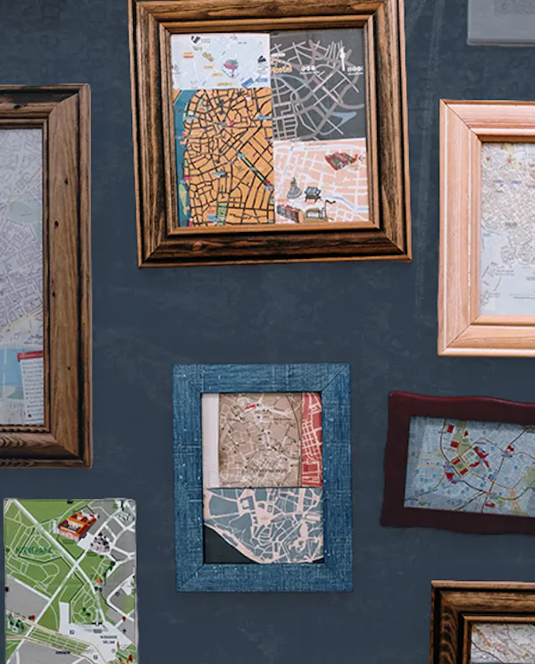 A wall of frames in different styles that show different types of maps