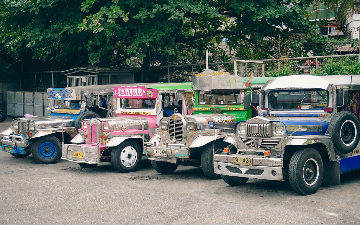 A lineup of brightly coloured buses and vehicles