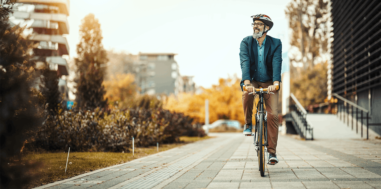 Man riding bike on sidewalk