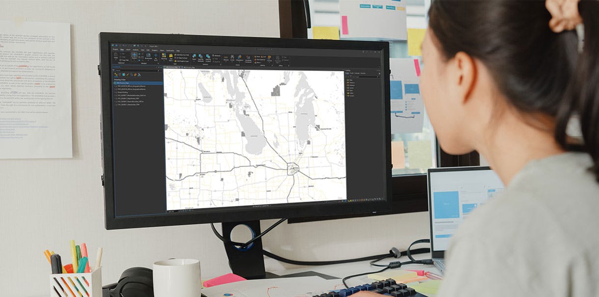 A woman analyzing a map displayed on the screen.