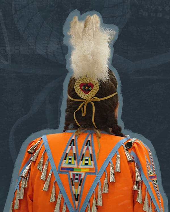 The back of a woman in customary Indigenous regalia with an orange jingle dress and three white feathers in her hair