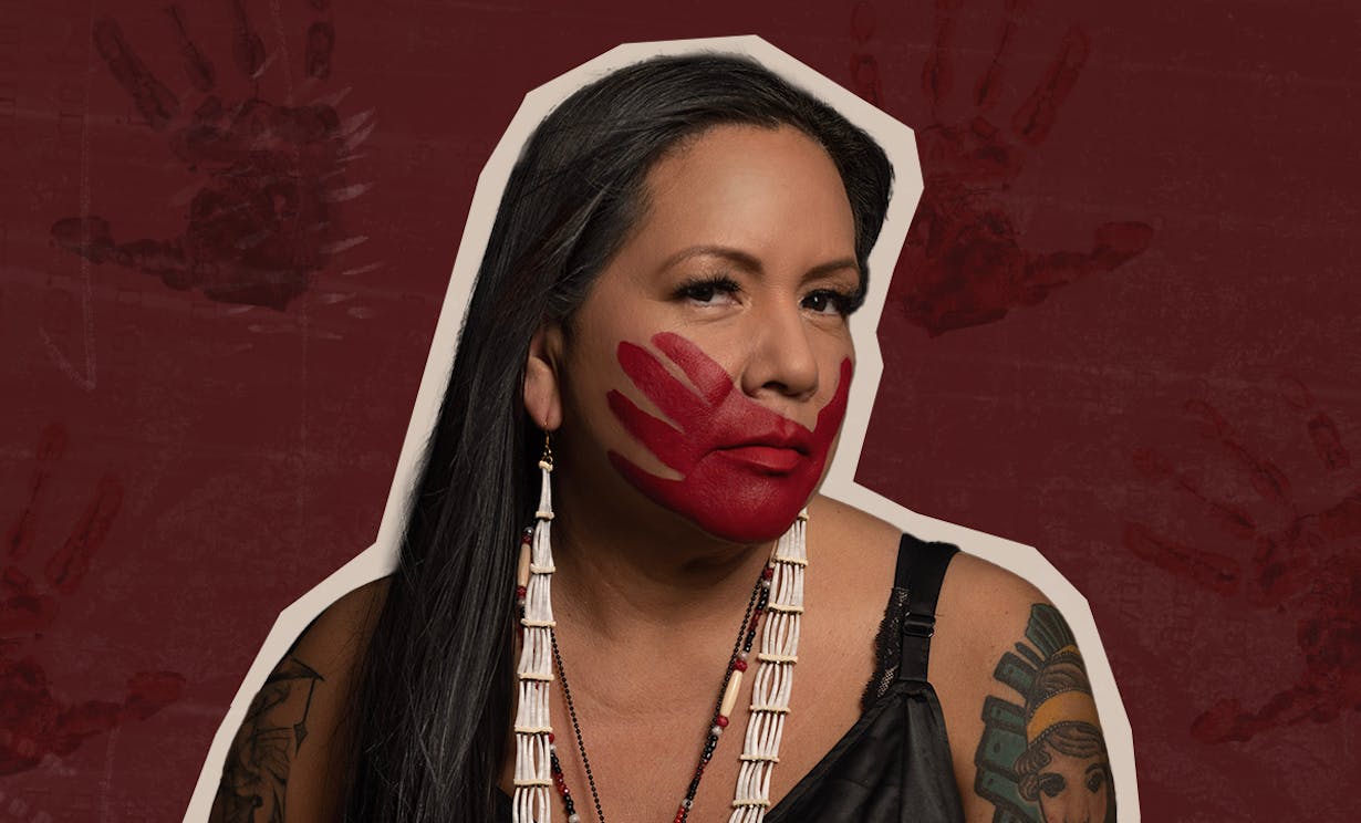 An Indigenous woman with a red handprint covering her mouth