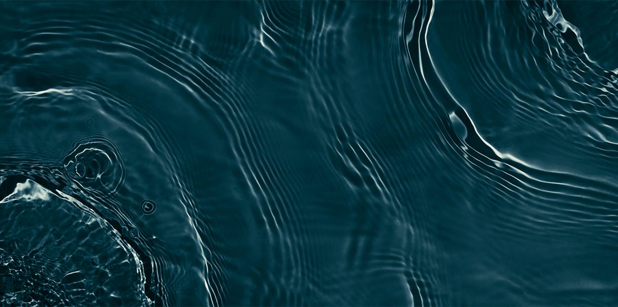 A close up view of multiple ripples in blue water