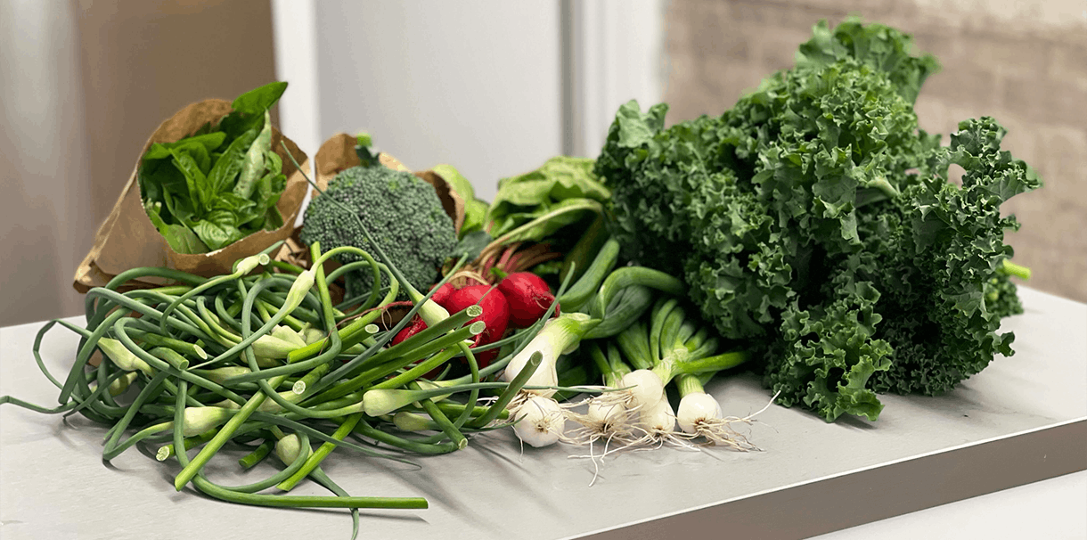 A display of local grown vegetables sitting on a counter