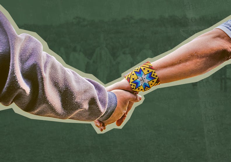 Two people hold hands. One wears a gray long-sleeve shirt, the other wears a colorful beaded bracelet against a green background.