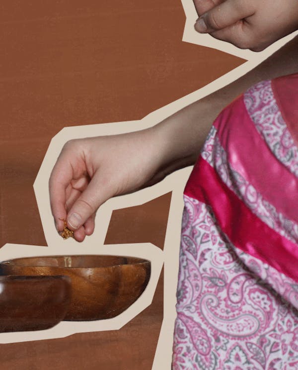 A women wearing a ribbon skirt takes loose tobacco from a wooden bowl