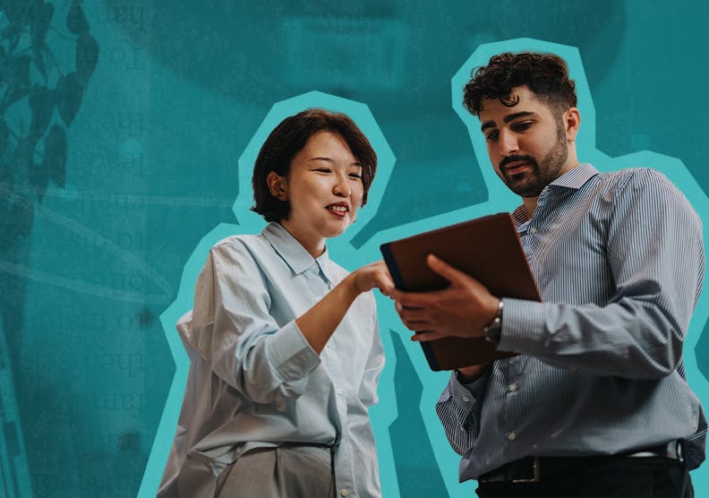 A woman and man review notes on a clipboard