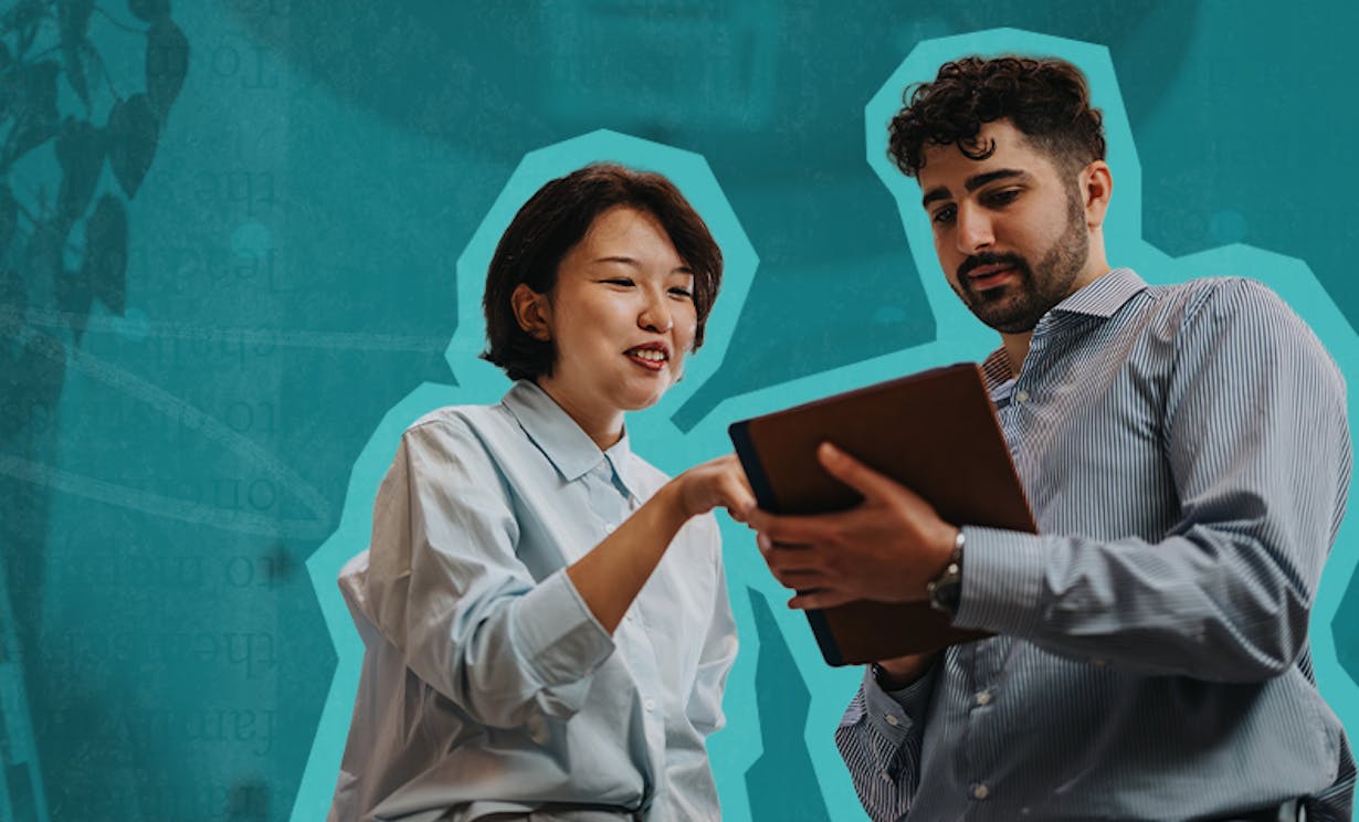 A woman and man review notes on a clipboard