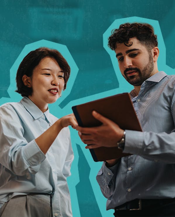 A woman and man review notes on a clipboard