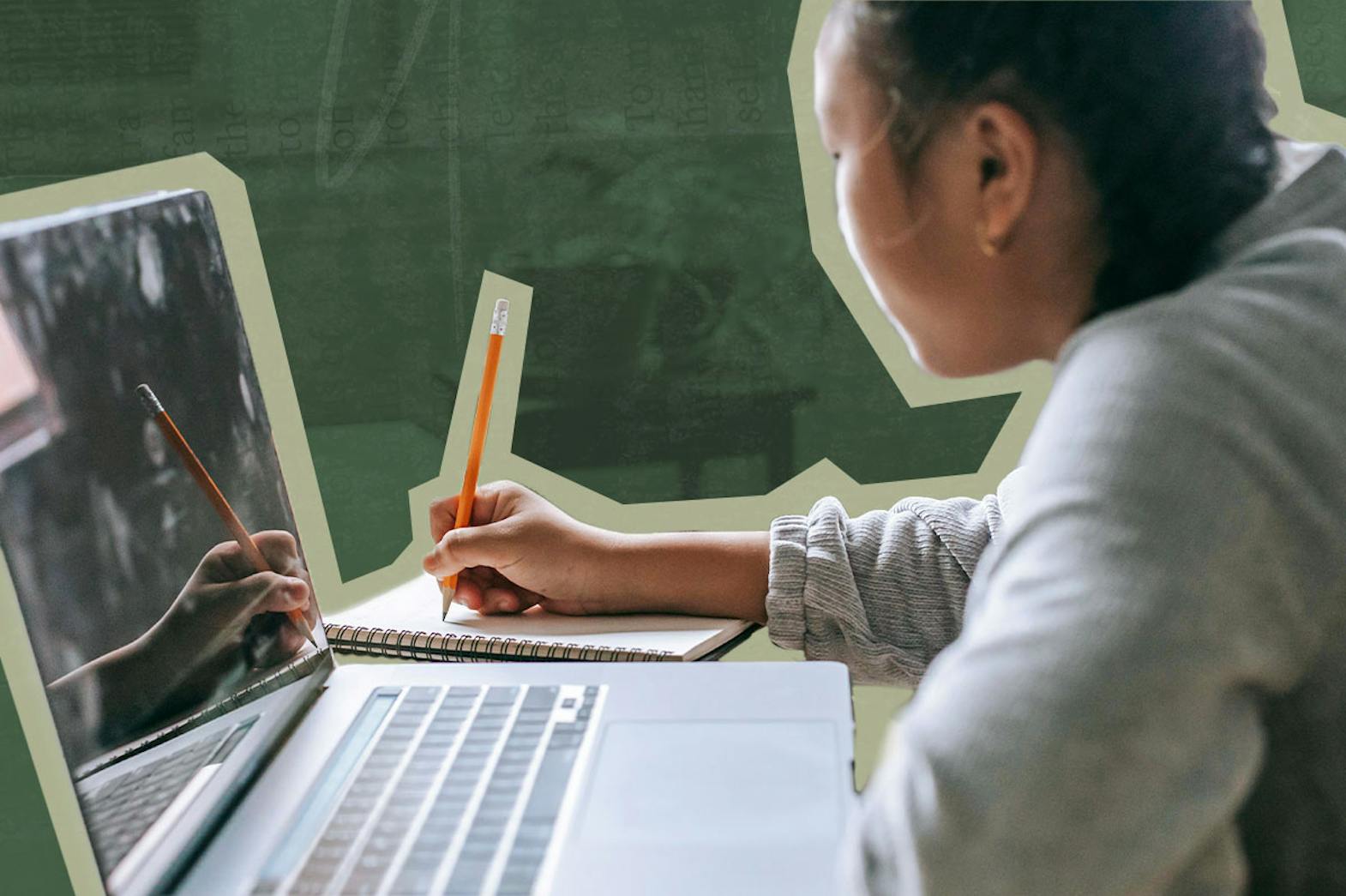 A woman writing on a notebook with a pencil. A laptop is sitting on the desk next to her