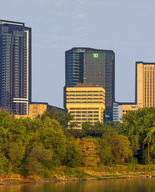Winnipeg skyline with a river at sunrise
