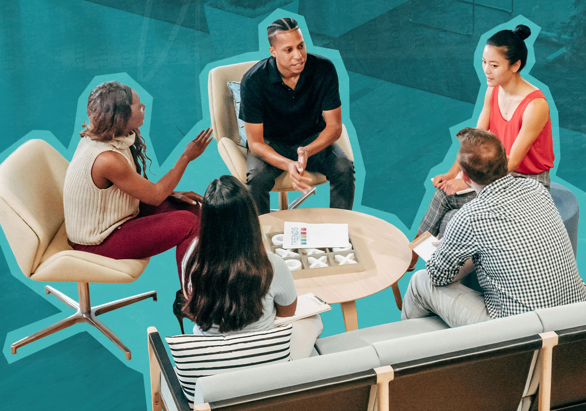 A group of diverse people sitting around a table conversing