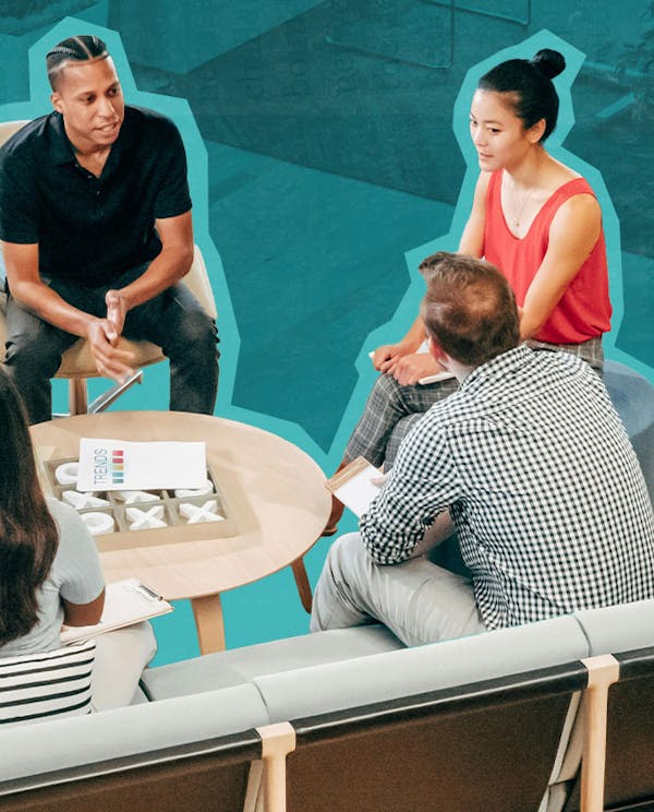 A group of diverse people sitting around a table conversing