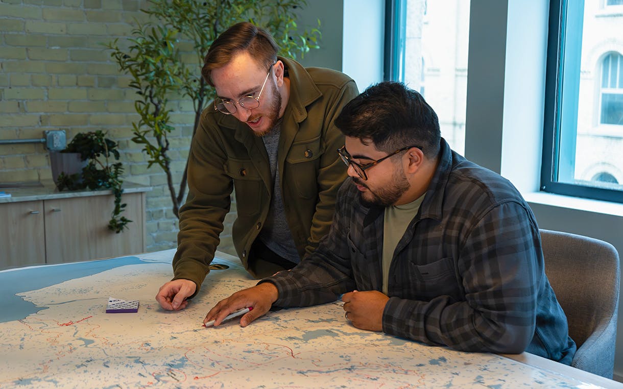 Brandon Klein reviewing a map with a coworker