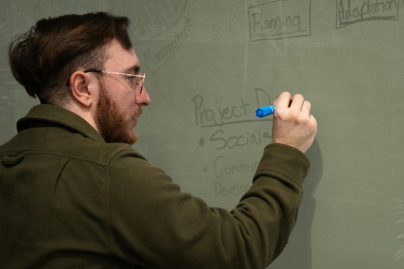 Brandon Klein writing on a whiteboard