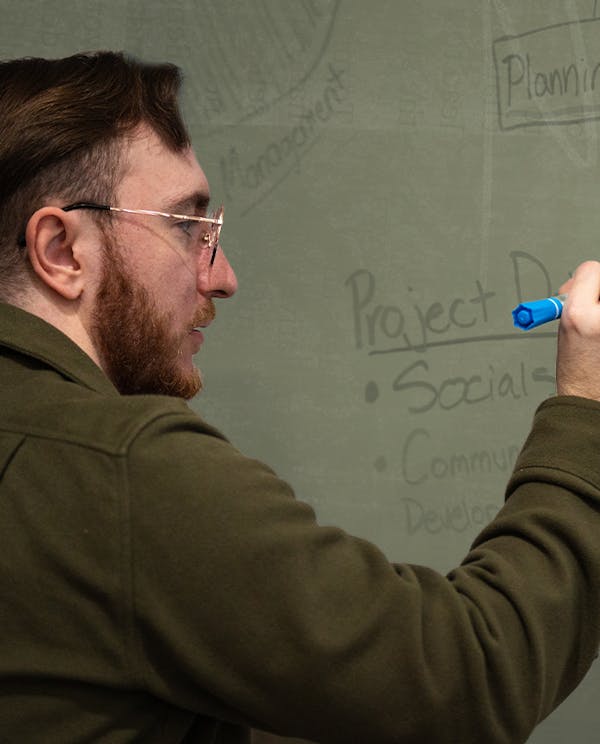 Brandon Klein writing on a whiteboard