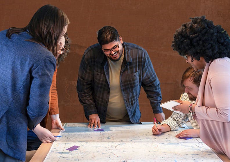 several people standing around a map