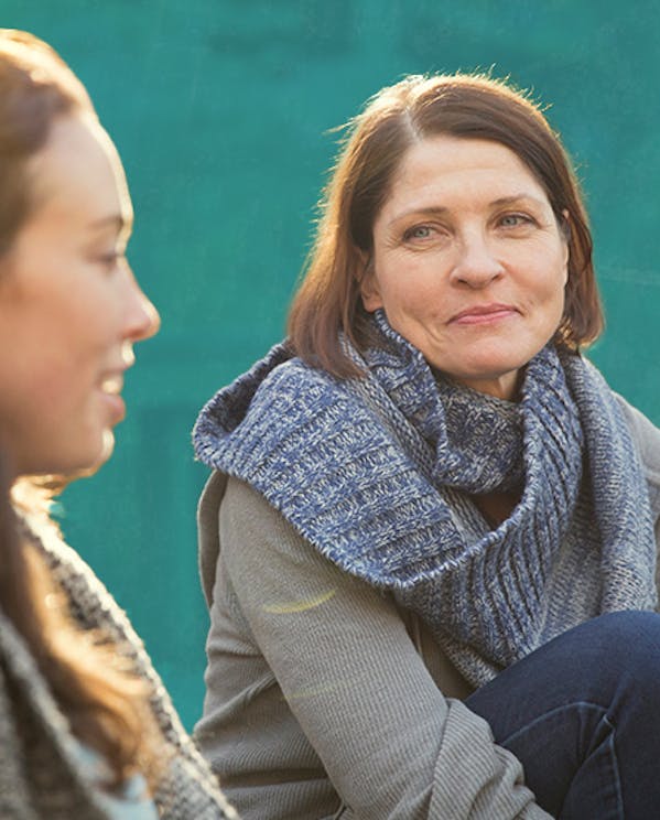Two women sitting outside and talking