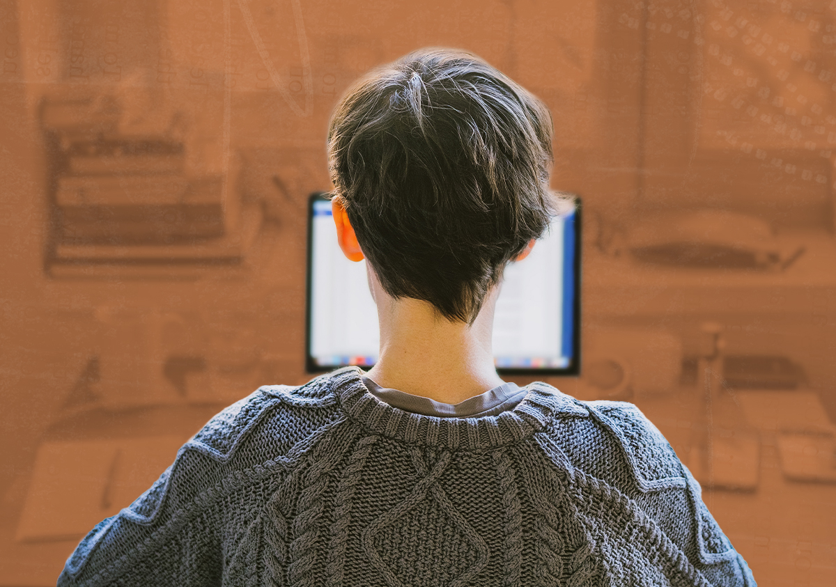 A woman working at her desk looking at her computer in her home office
