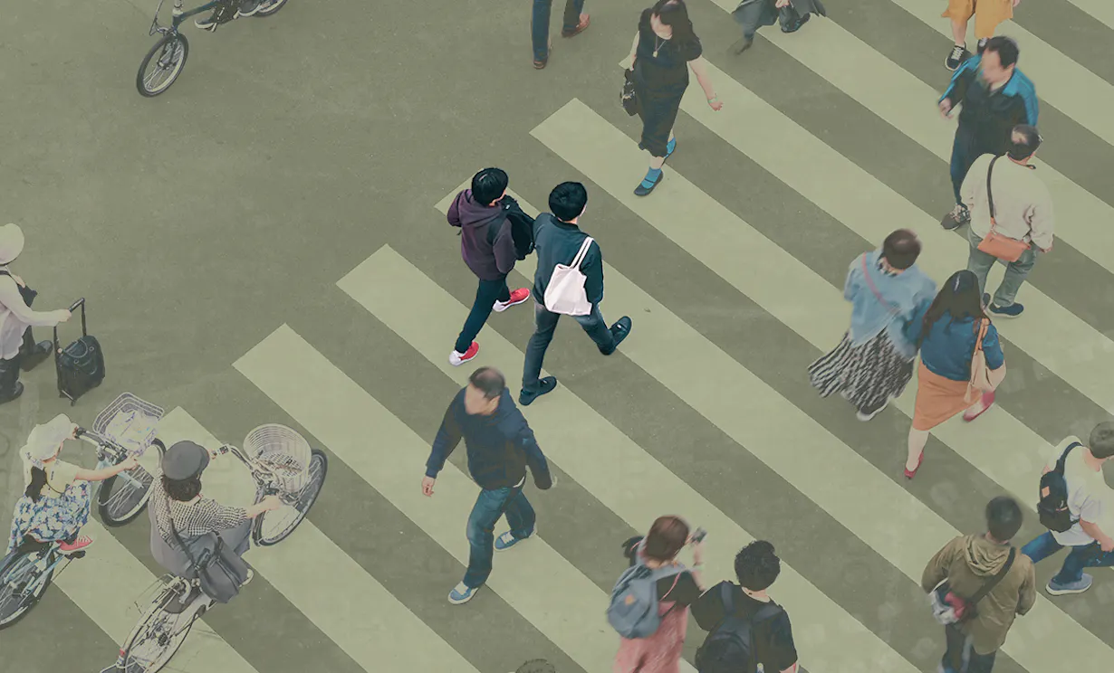 Birds eye view of people crossing a busy crosswalk