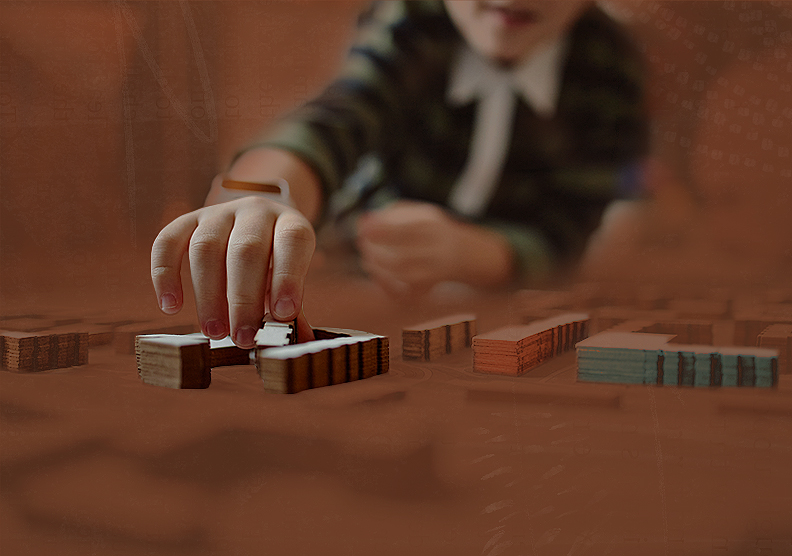 A child playing with wooden building blocks on a coffee table.